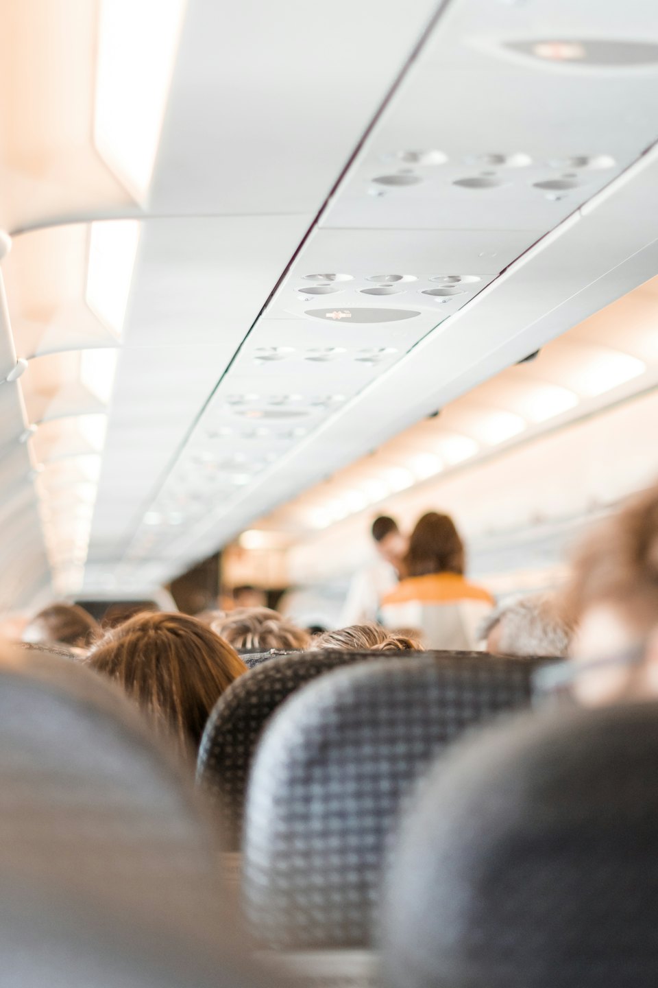 Passengers seated in an airplane cabin during a flight.