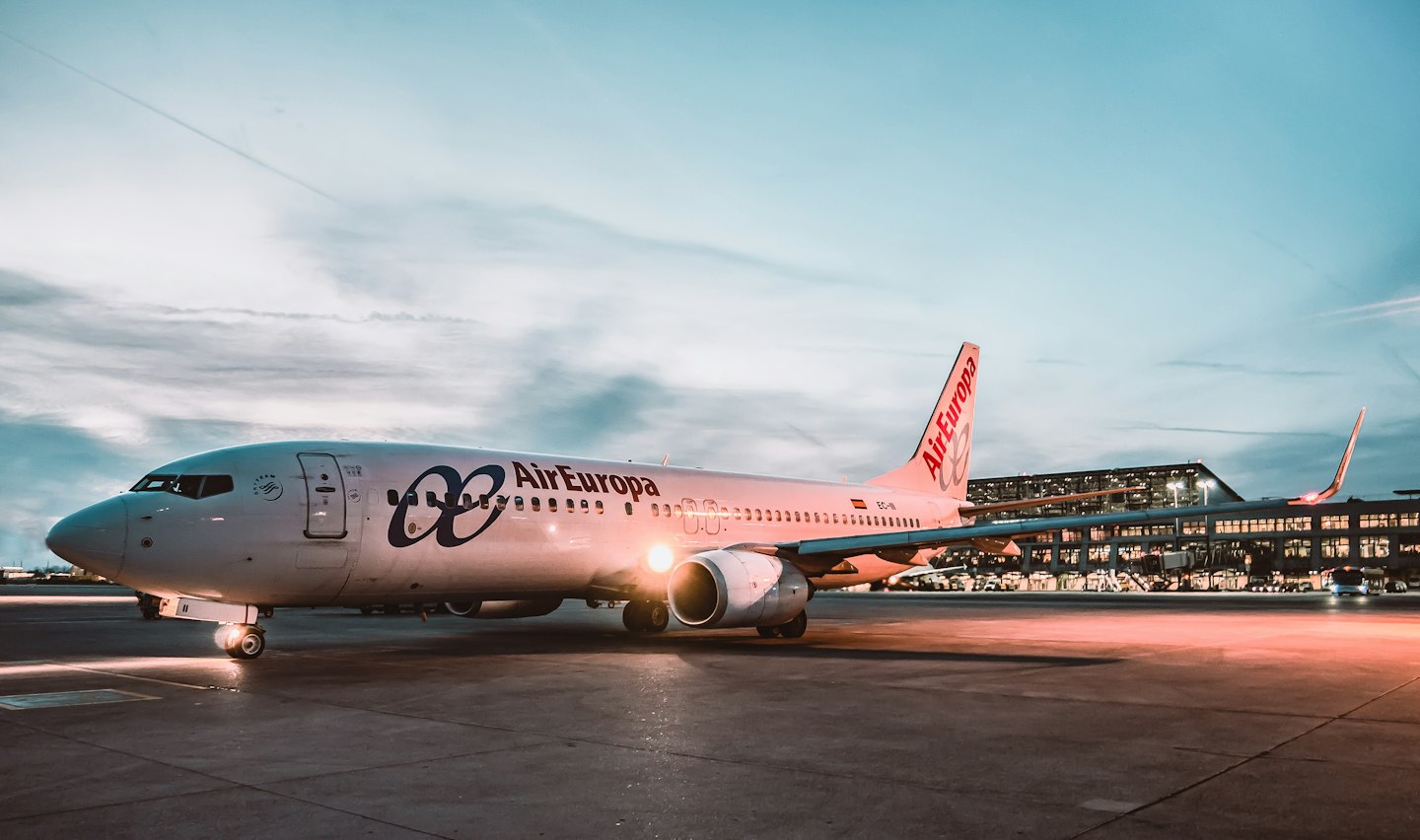 Air Europa passenger jet parked on the airport tarmac at night.